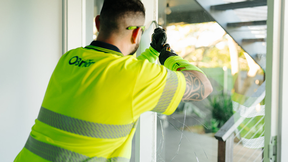 A glazier is replacing a glass window