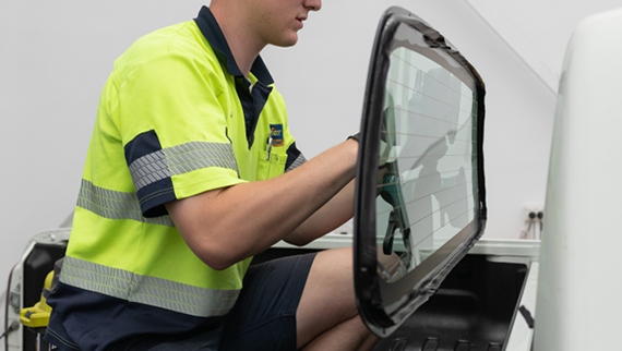 O'Brien® staff member holding a glass panel.