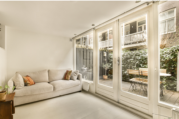 Stylised shot of a living room with large glass doors.