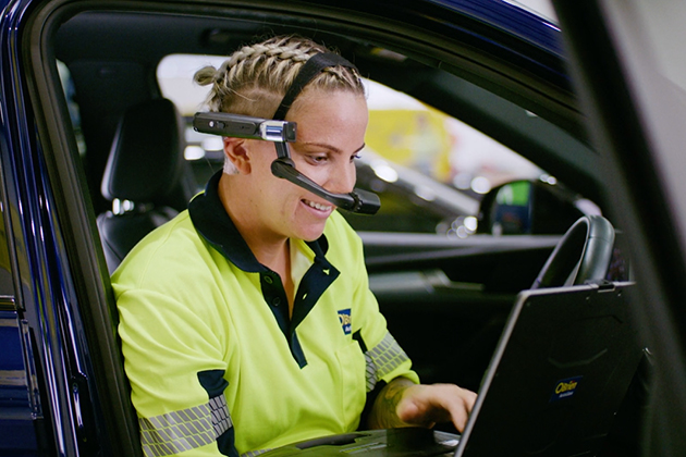 O'Brien® staff member using a laptop in a car.