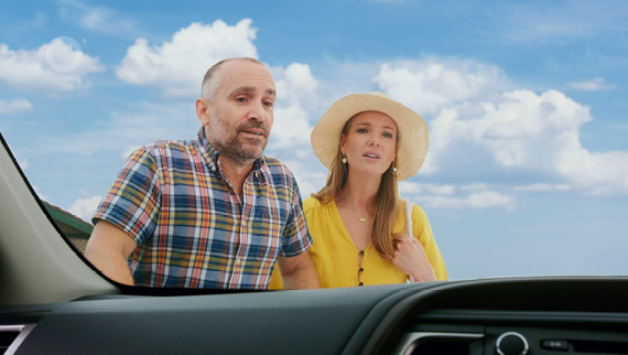 Concerned couple looking at a car windscreen.