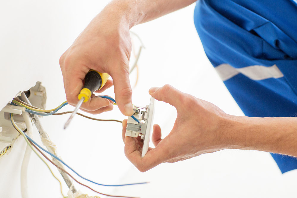 An Electrician Rewiring An Outlet at a home in Bendigo