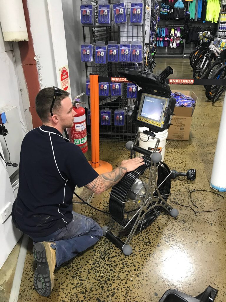 Plumber performing CCTV Drain Inspection on the Central Coast
