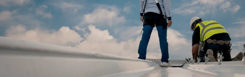 Roof plumbers on an industrial roof