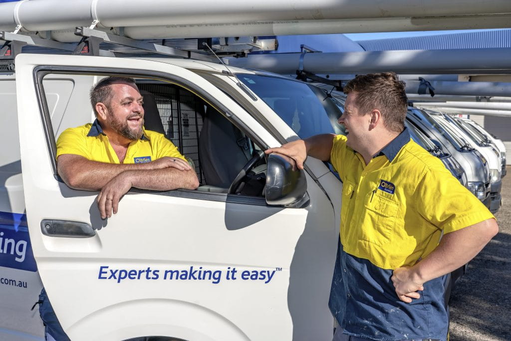 O'Brien Port Macquarie plumbers and roofers standing at mobile van ready for a job