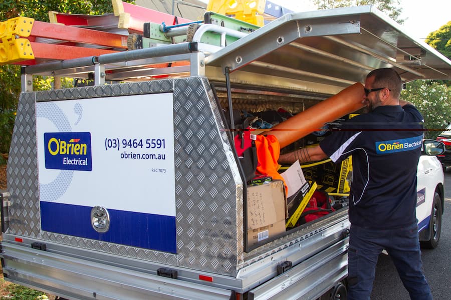 electrician in Thomastown, Vic getting tools from ute