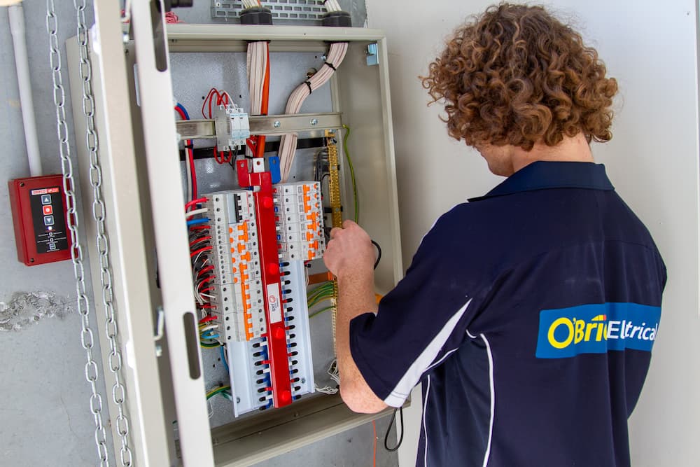 Electrician in Thomastown installing and testing switchboard