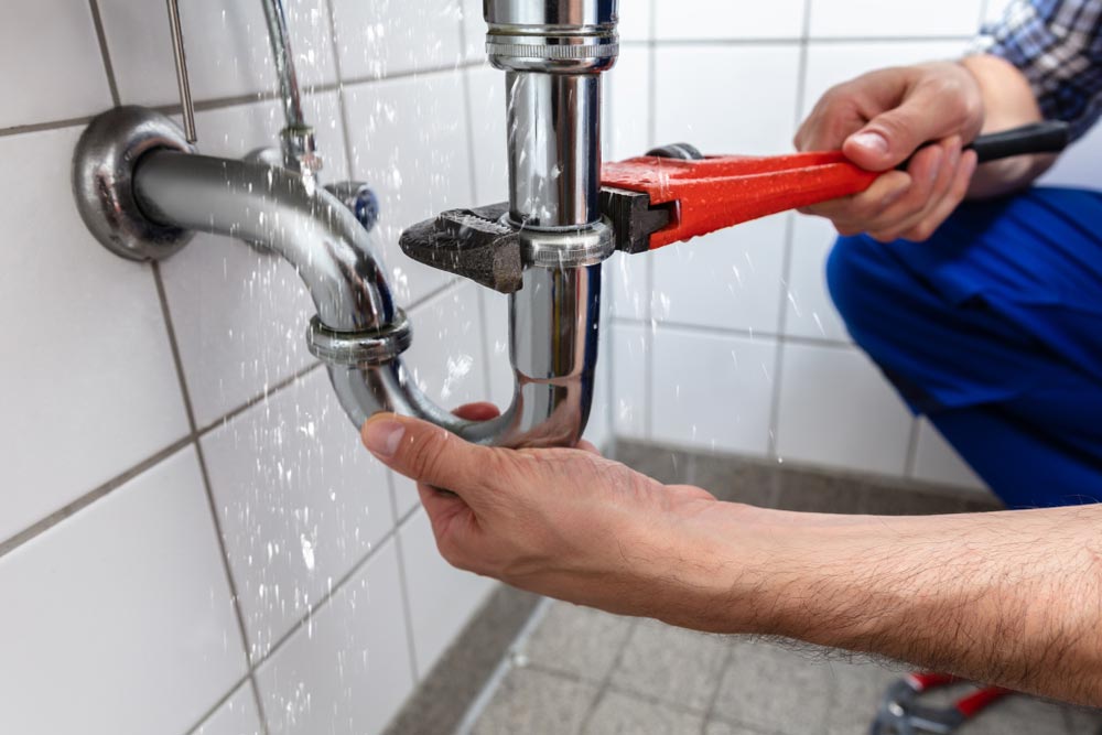 Plumber Fixing Leaking Pipes