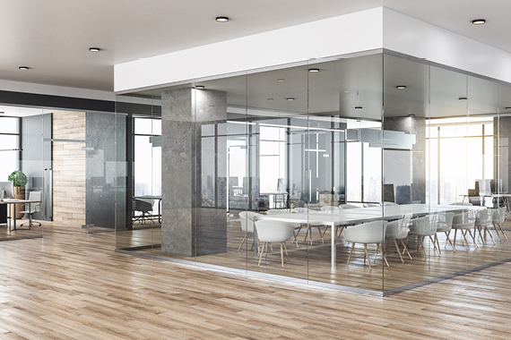 Stylised shot of an office with wooden floors and floor-to-ceiling windows.