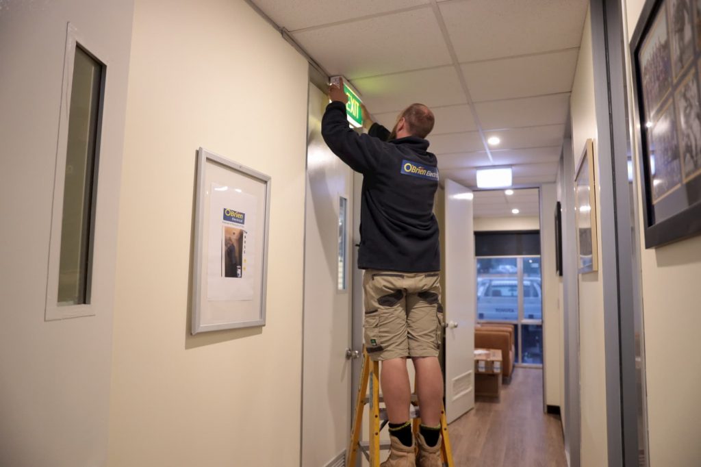 O'Brien electrician installing exit light - Castle Hill