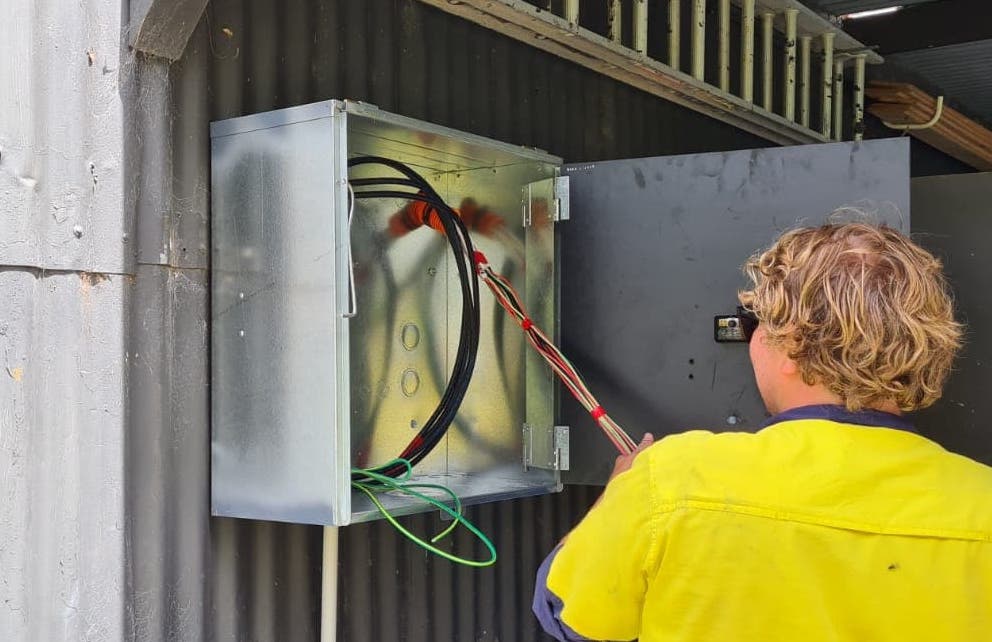 electrician in Port Macquarie fixing wiring in workshop