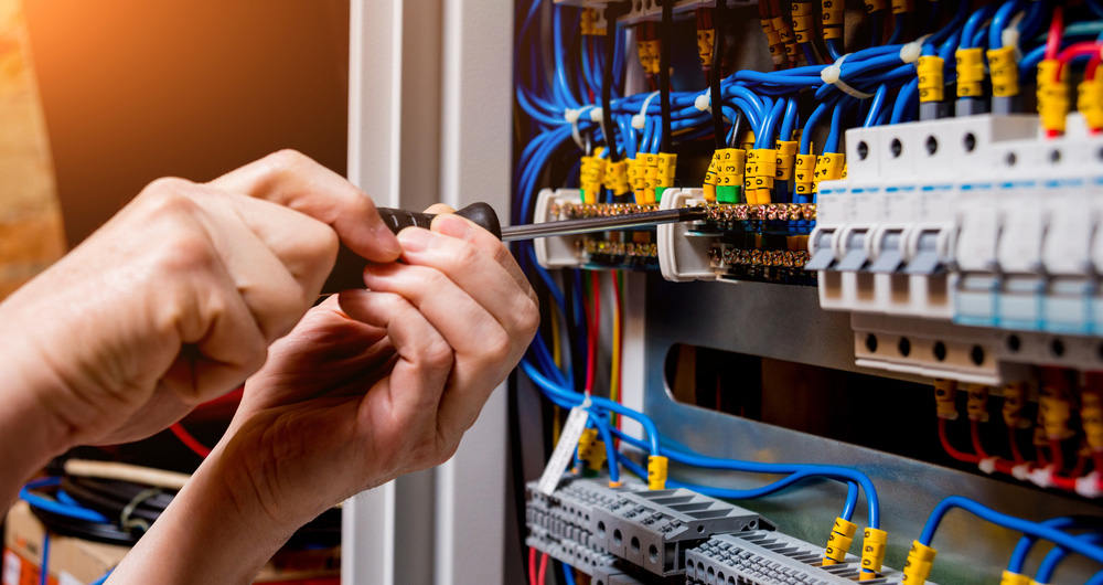 Man Upgrading A Switchboard