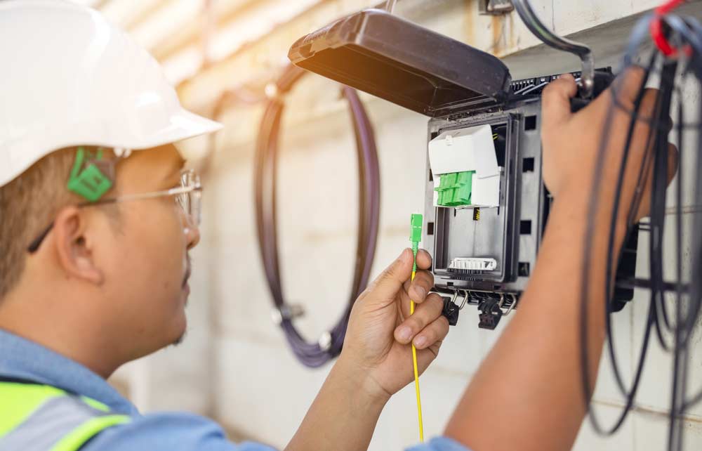 Technician Repairing A Fiber Optic Connection