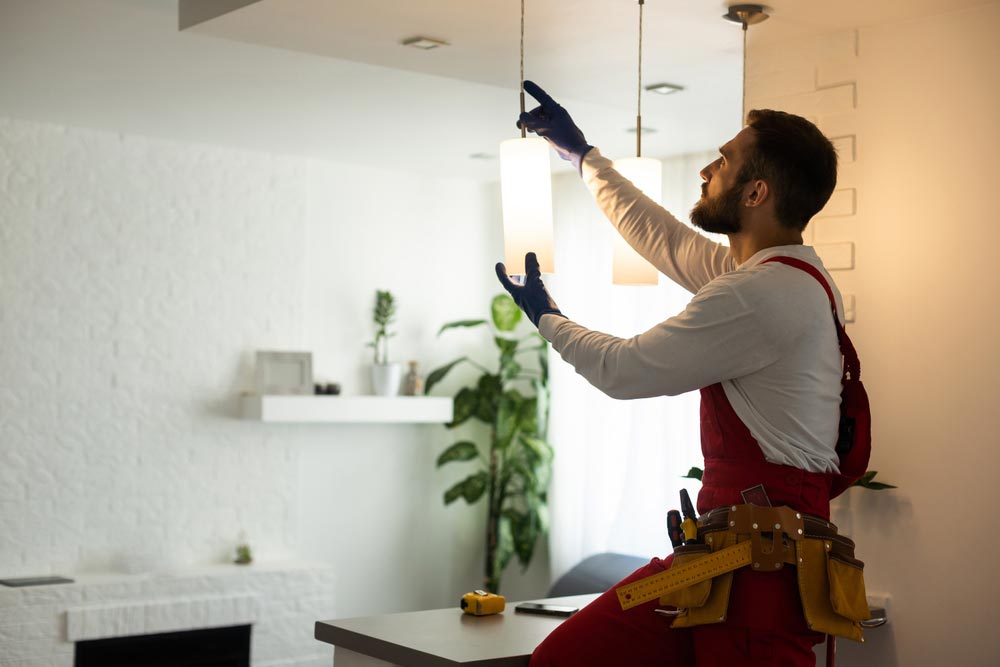 An electrician Installing An LED Light in a home in the Eastern Suburbs