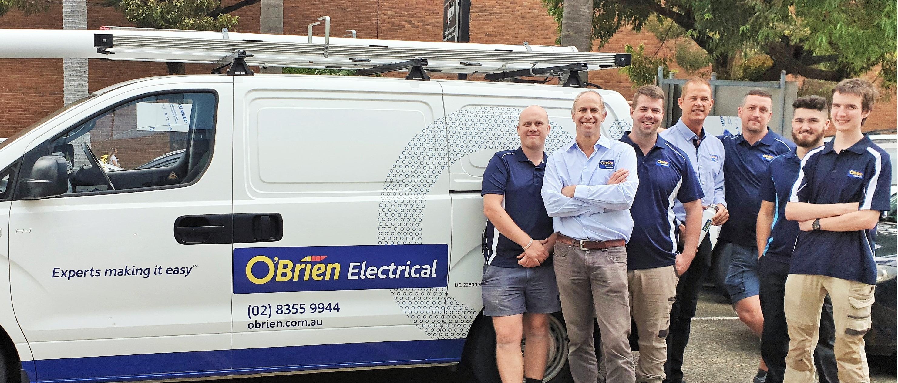 The O'Brien Electrical Alexandria team standing next to the work van