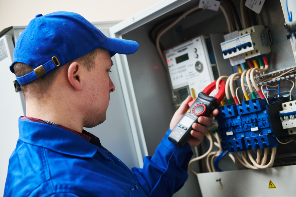 electrician-with-multimeter-tester-in-switchbox