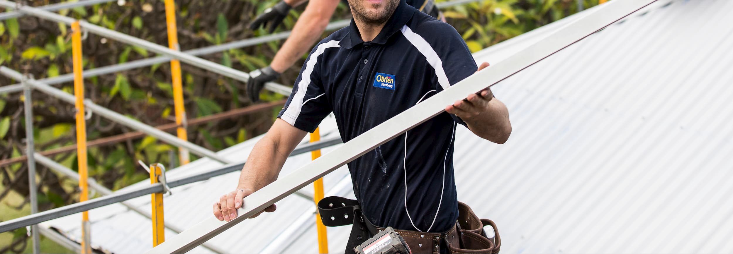 roofing and guttering contractor on a roof