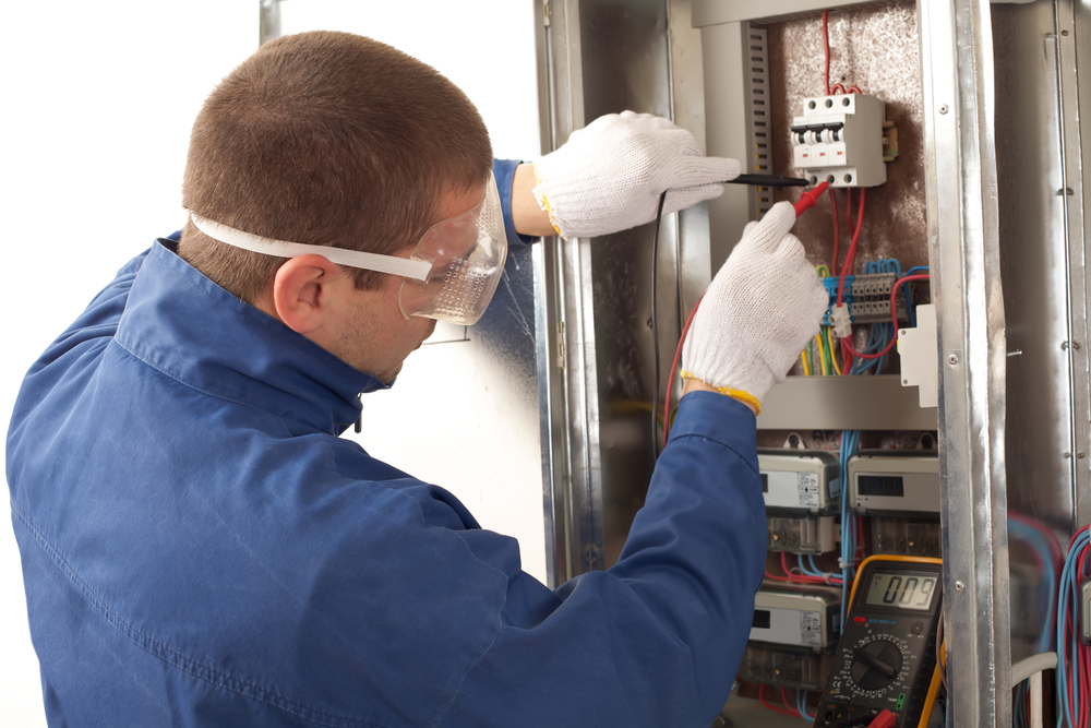 An electrician testing a switchboard in Noosa