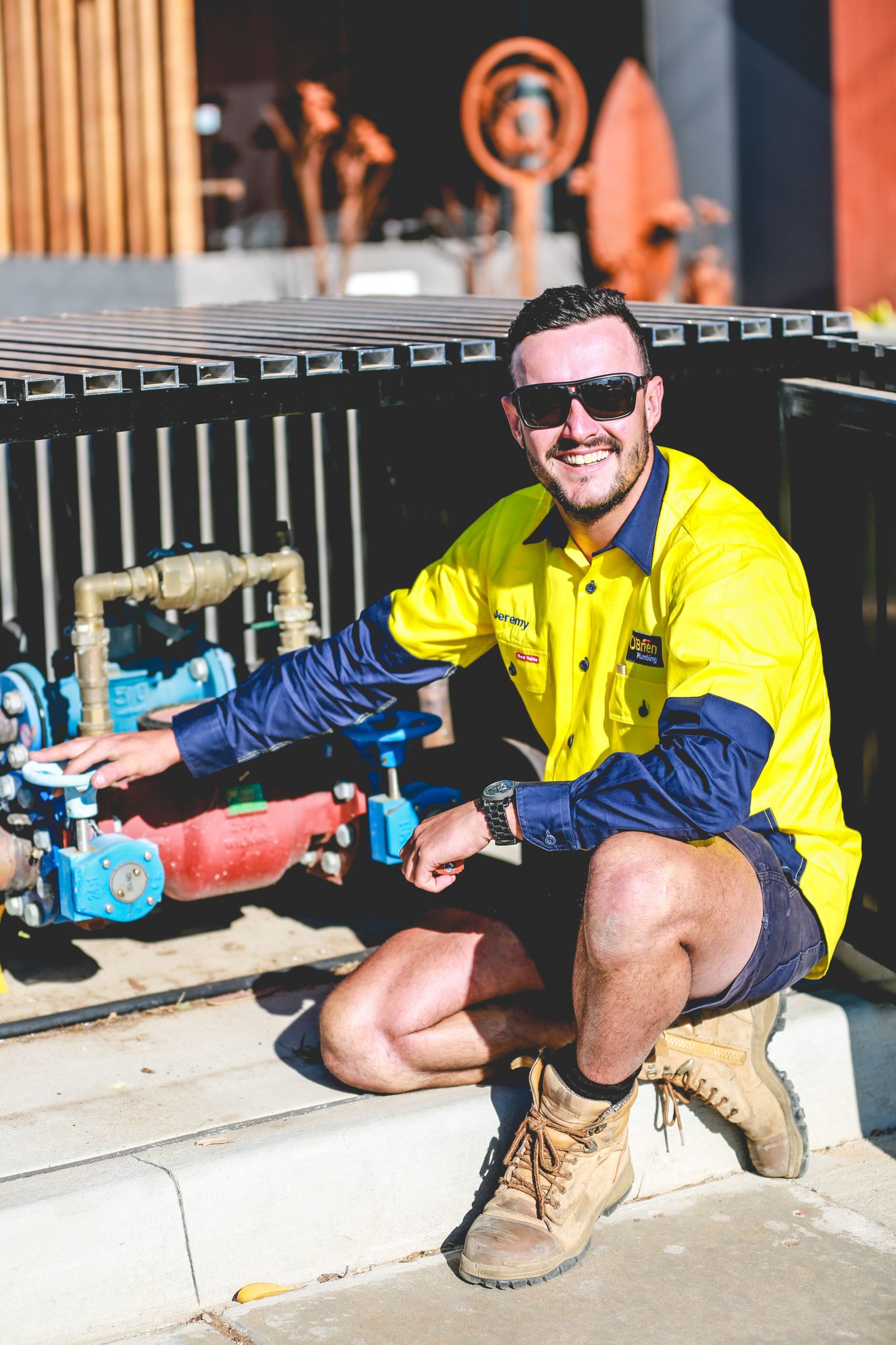 smiling-plumber-with-backflow-device