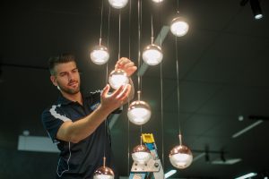 an electrician repairing commercial lighting in Camberwell