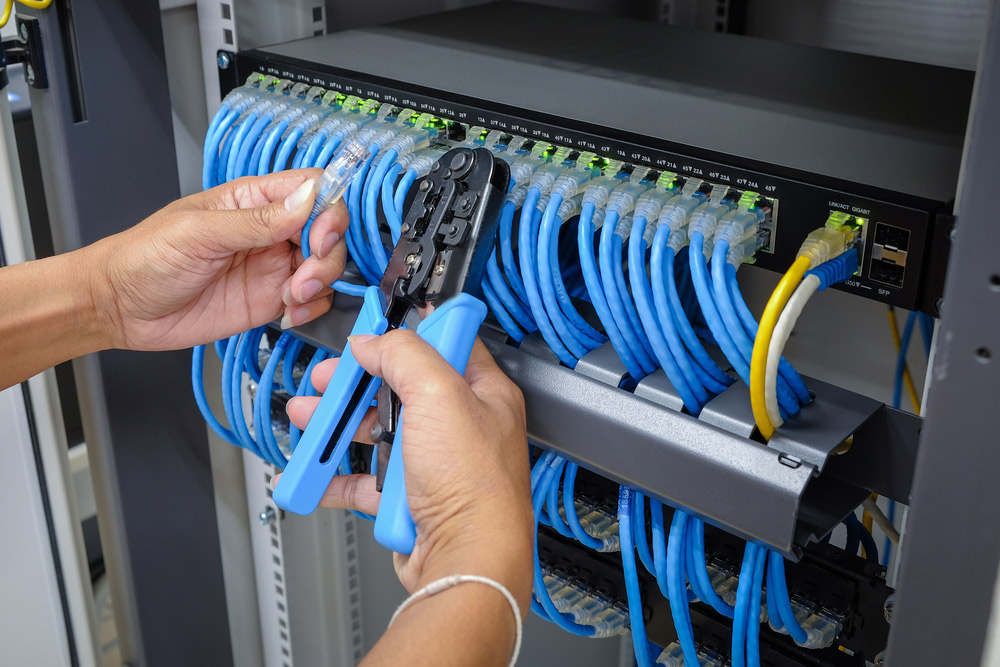 An electrician installing data cabling in a business in Yamba