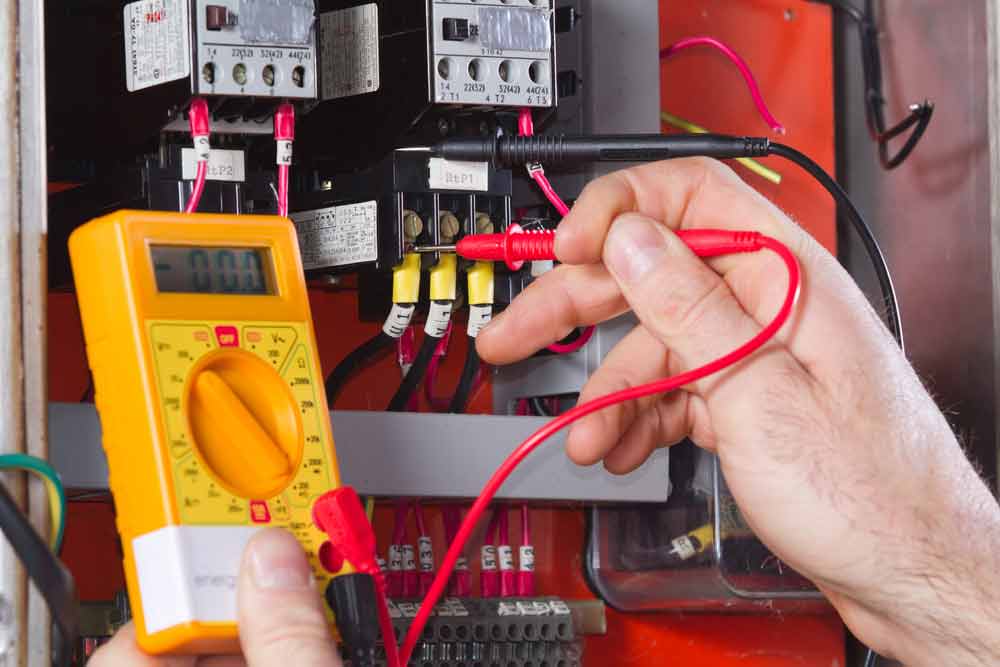 Electrician doing electrical maintenance using multimeter tester