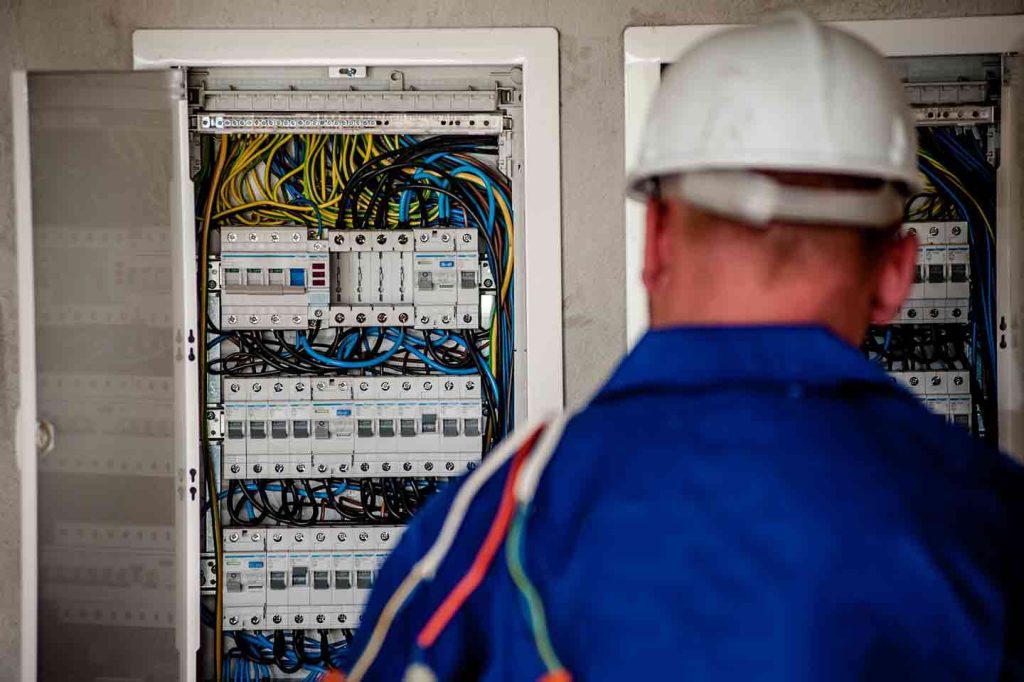 Man In Blue Shirt Doing Electrical Maintenance