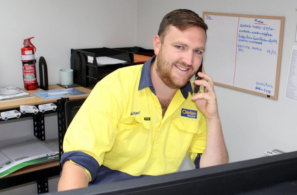 Electrician in Dubbo answering phone call