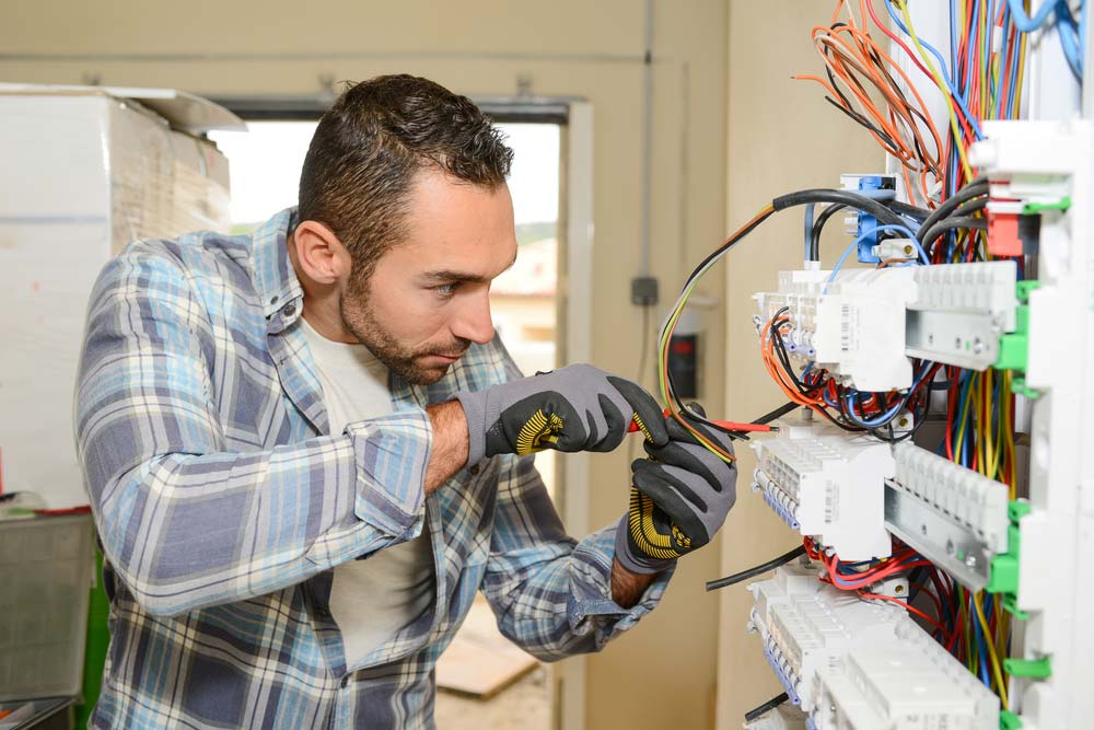 Electrician Working On Power Cabling