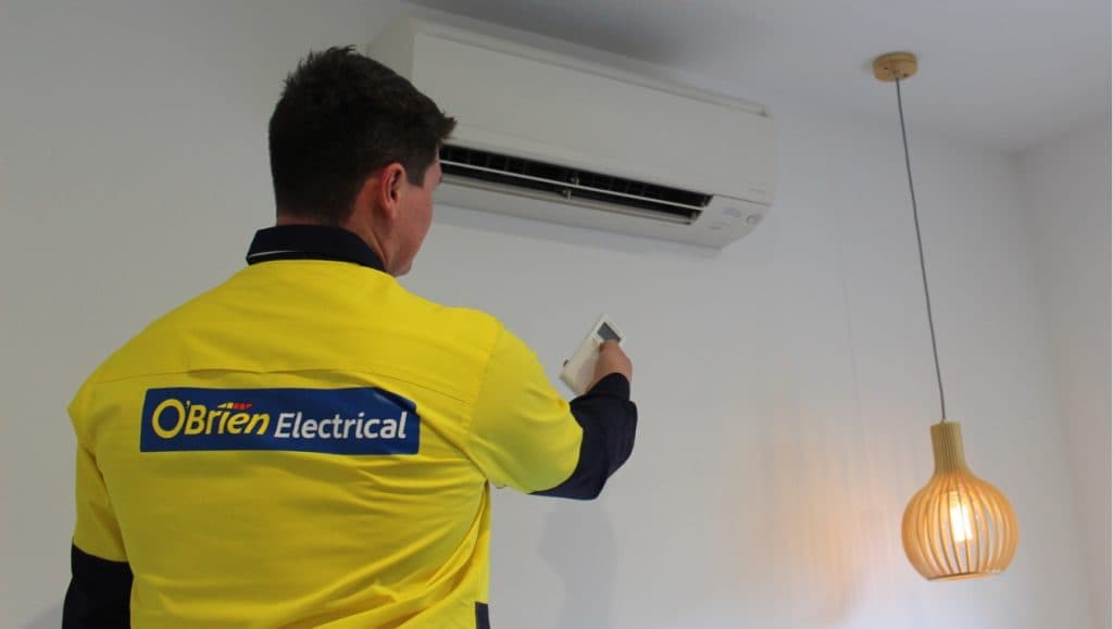 Electrician installing split system air conditioning in Bendigo home
