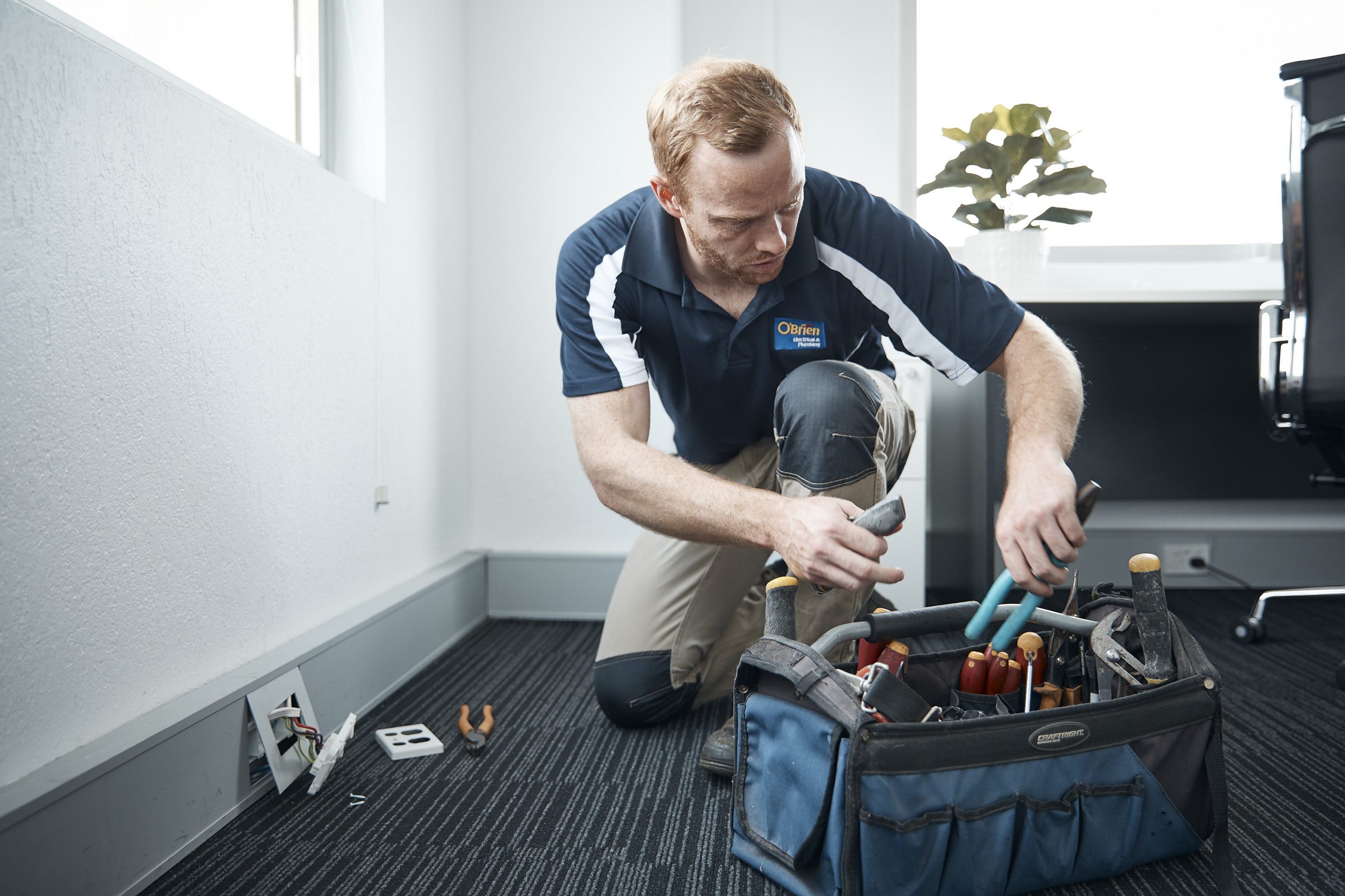 An electrician working in a home in Yamba