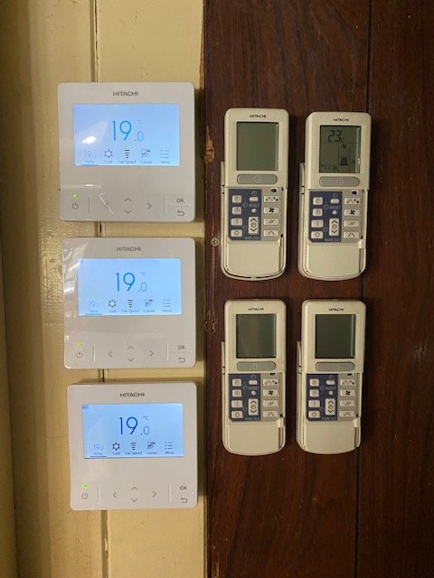 New air conditioner remotes on a wall