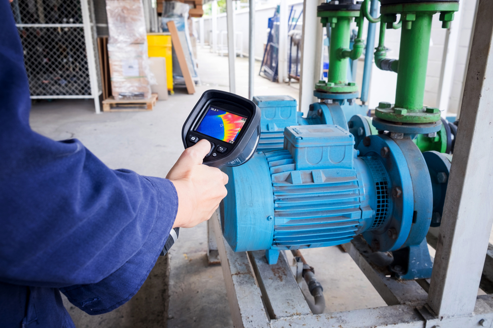 An electrician using a thermal imaging scanner