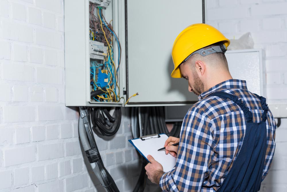 Professional Electrician Inspecting Wires