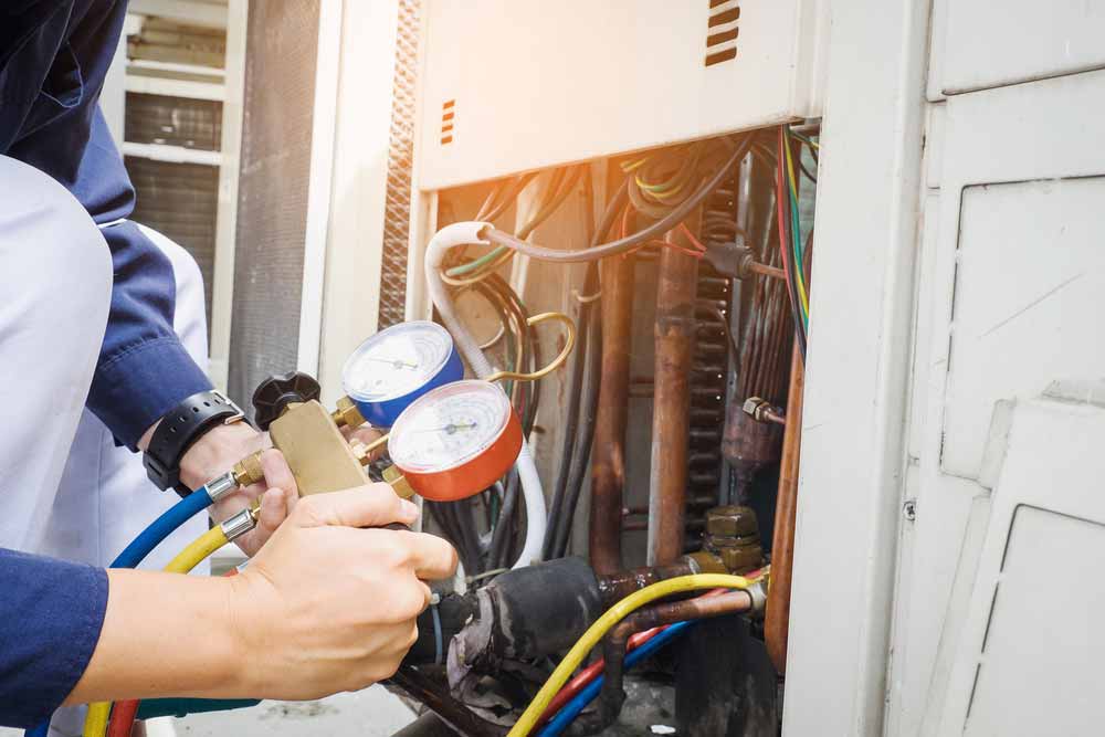 Technician checking the electrical wiring of an appliances