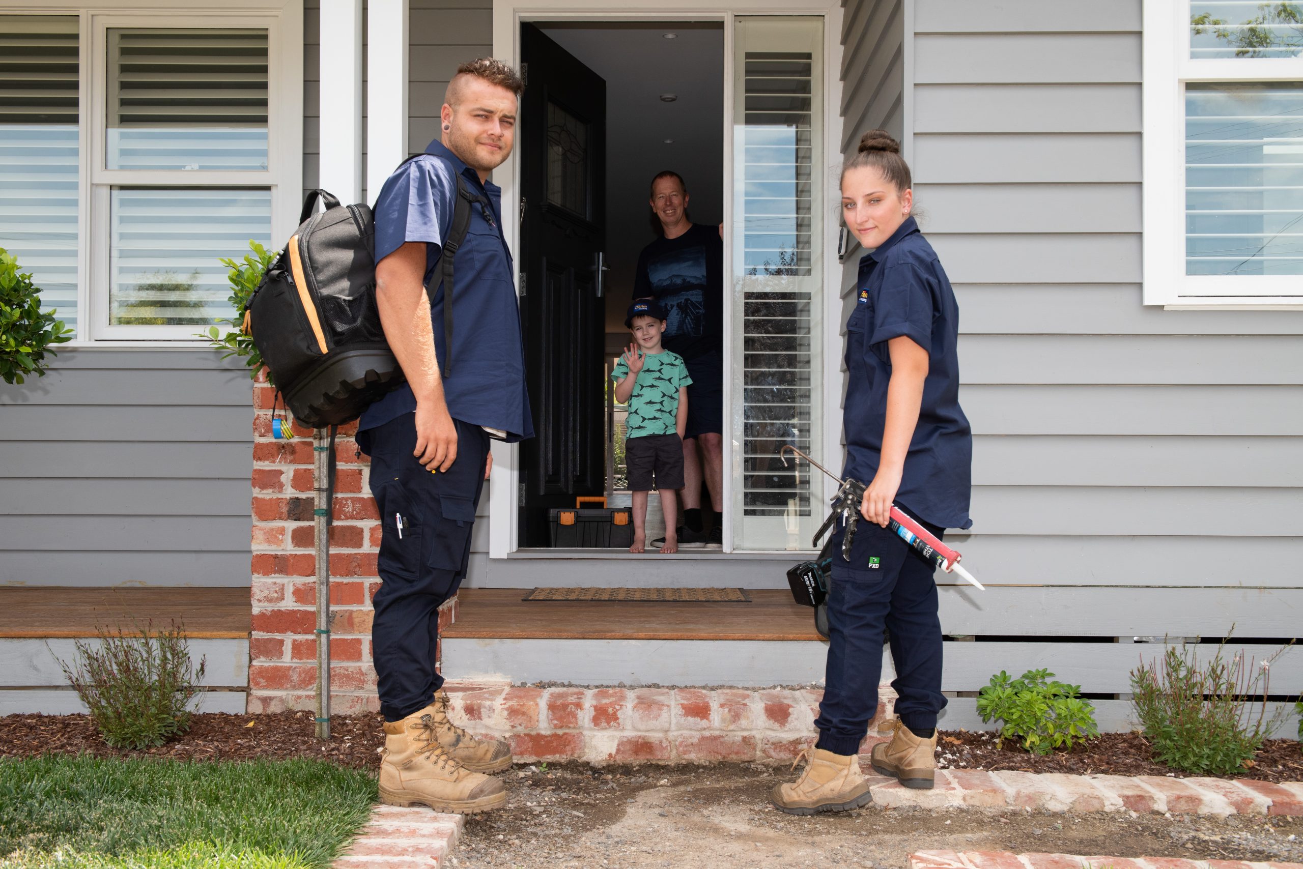 O'Brien plumbers greeted by customer and child in the front door