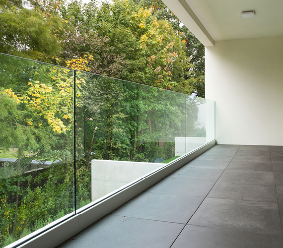 Newly installed glass balcony overlooking trees.
