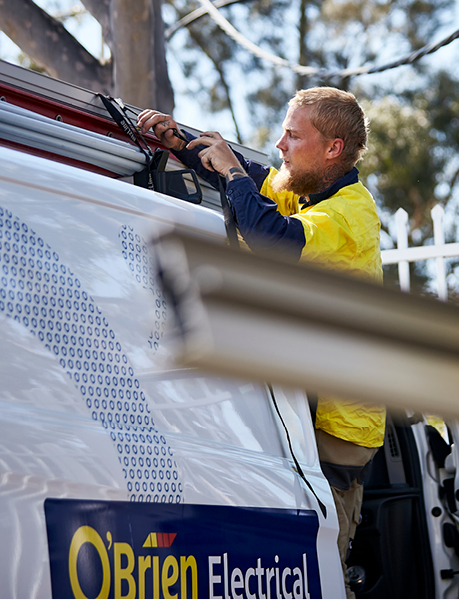 O'Brien Electrician securing ladder to an O'Brien Electrical Van