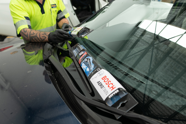O'Brien® Autoglass staff member installing Bosch windscreen wipers.