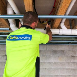 Plumber Checking On Pipes During Renovation